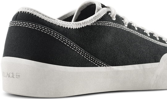 Black sneaker with white sole on a white background