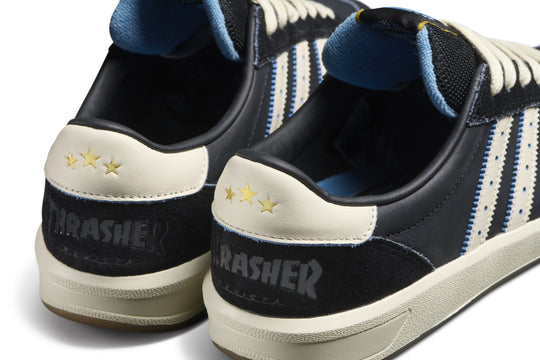 Black and white sneakers with blue accents and &