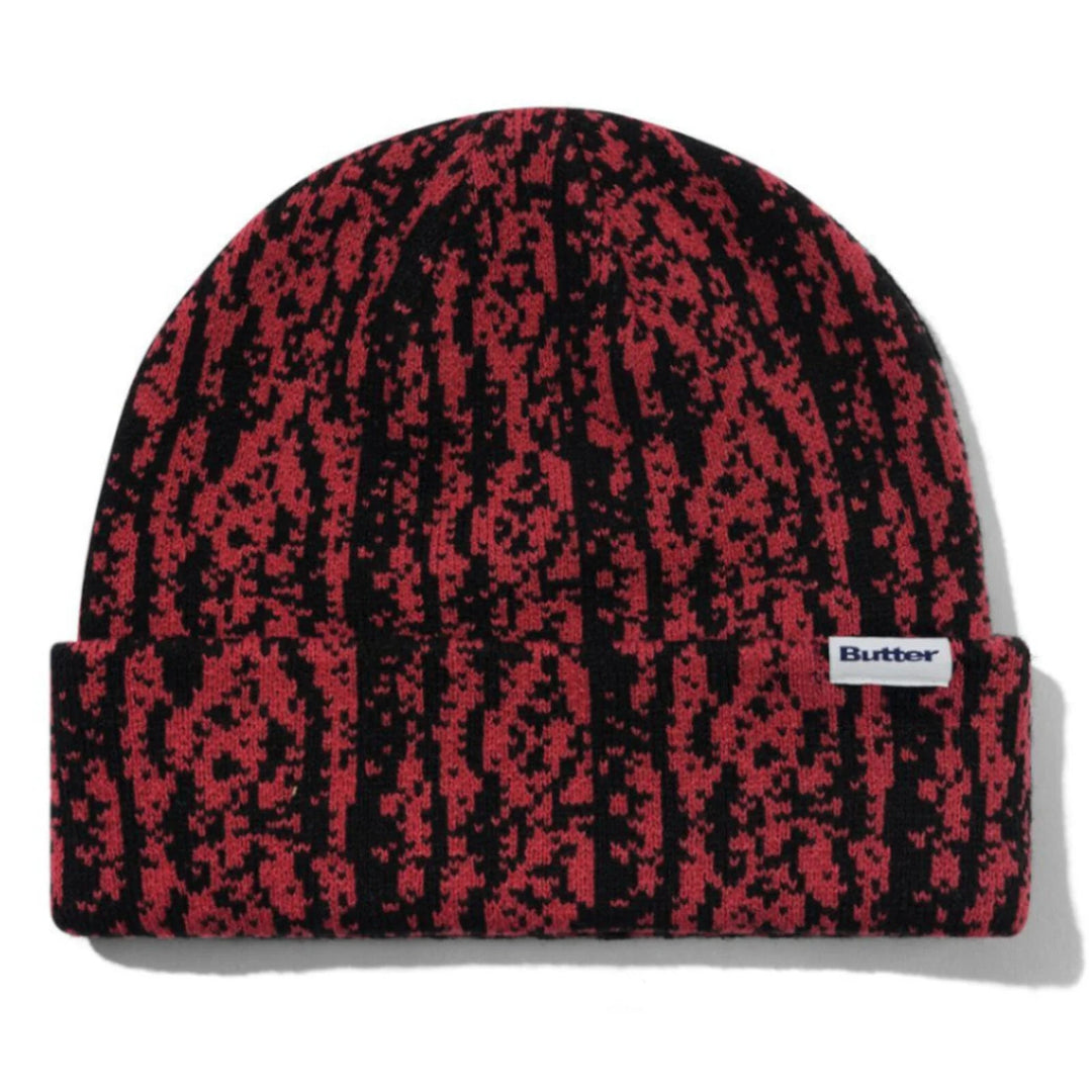 Red and black patterned beanie with a butter brand logo 