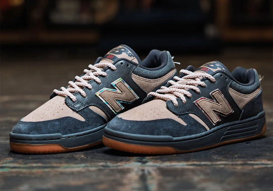 Pair of navy and beige sneakers with &