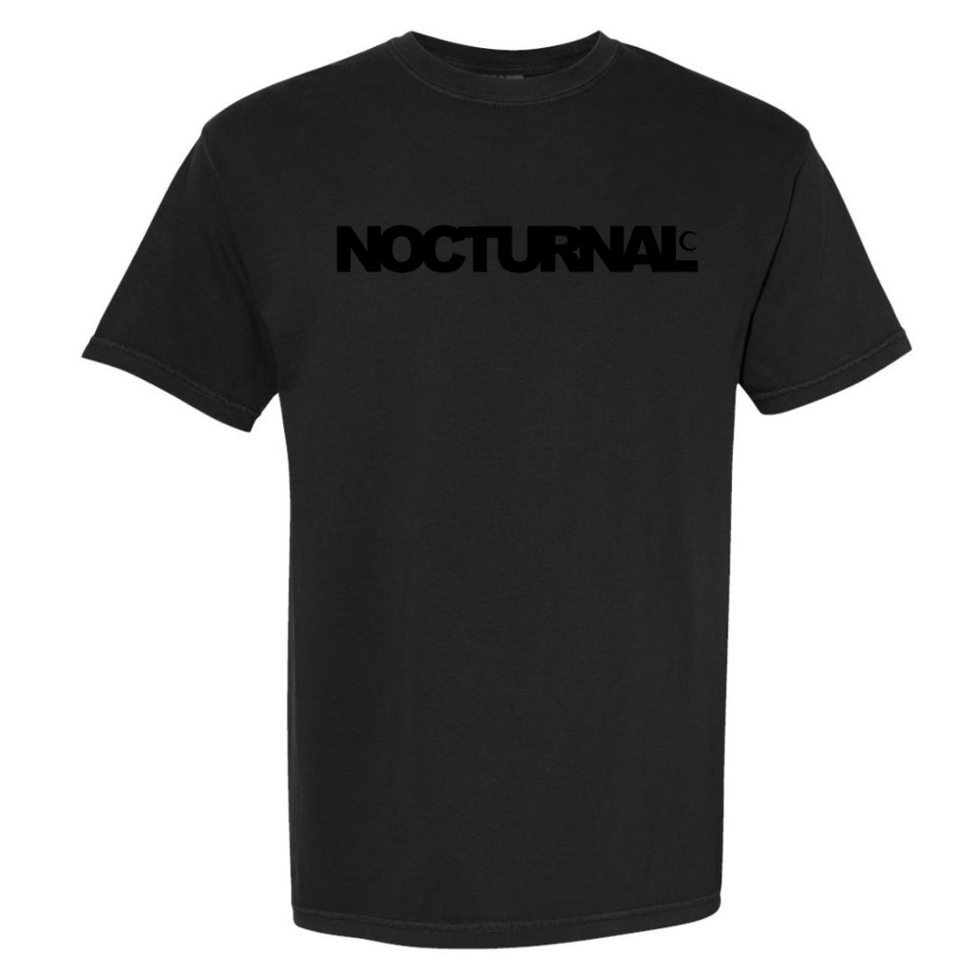 Black t-shirt with 'NOCTURNAL' text on a white background