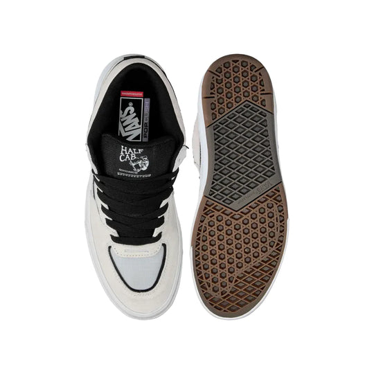 White and black sneaker with brown sole on a white background