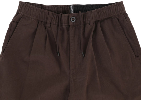 Brown pants with a button and zipper on a white background