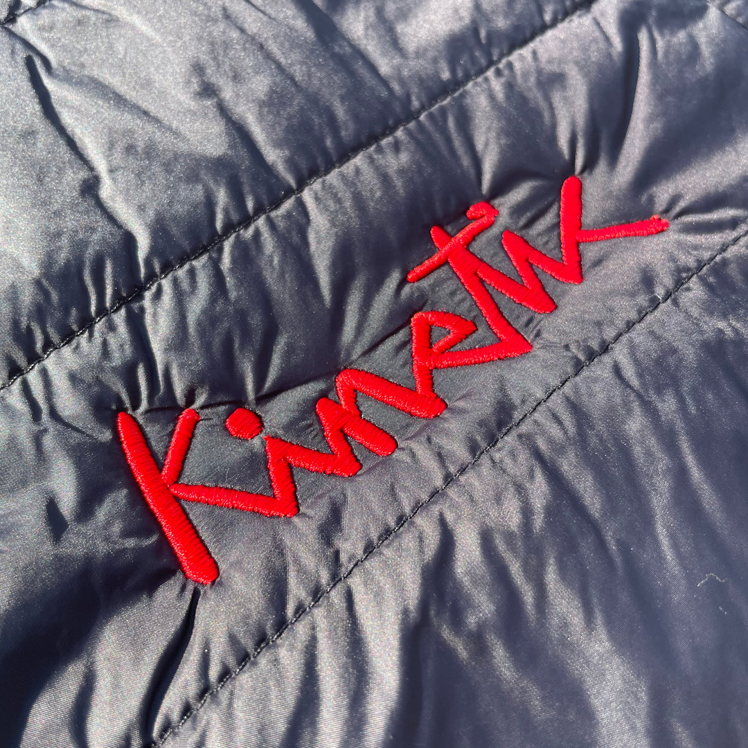 embroidery detail on a kinetic red logo